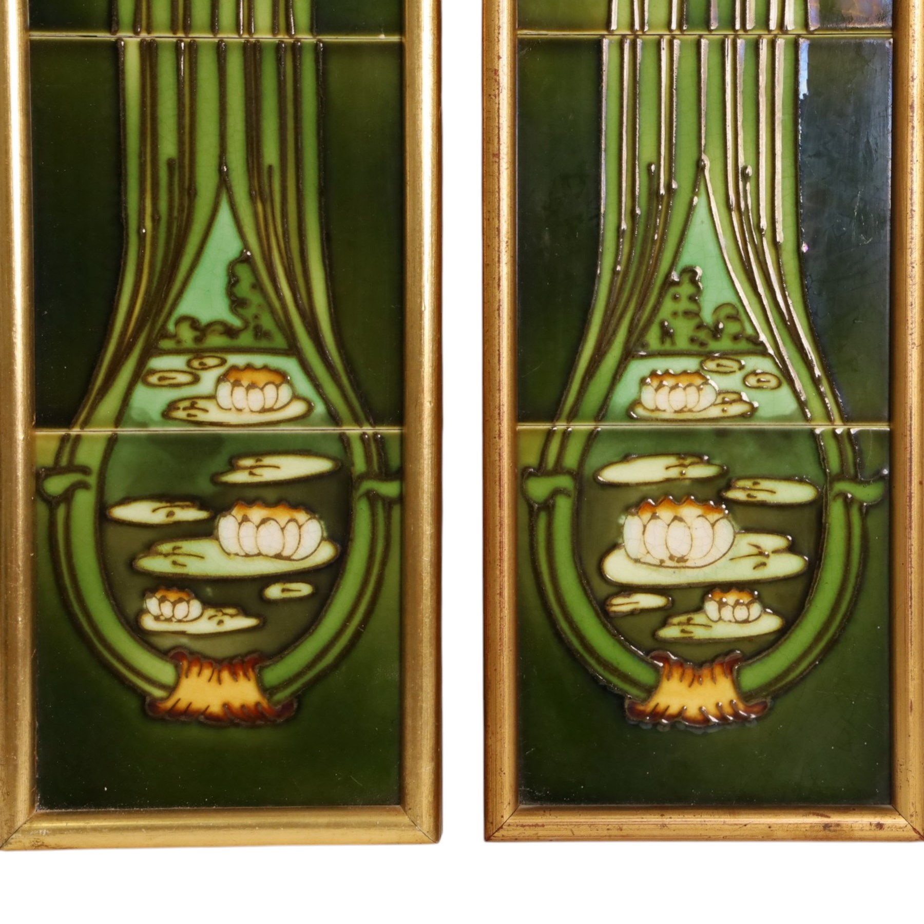 Pair of framed Art Nouveau fireside tile sets, each with five tube-lined tiles one depicting a kingfish, the other a swallow, above bulrushes, with a white lily pond beneath, H79cm
