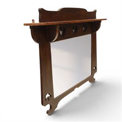 Arts and Crafts oak wall mirror, rectangular mirror plate within shaped frame, raised shelf with shaped back and pierced heart detail, bracket supports and shaped lower rail