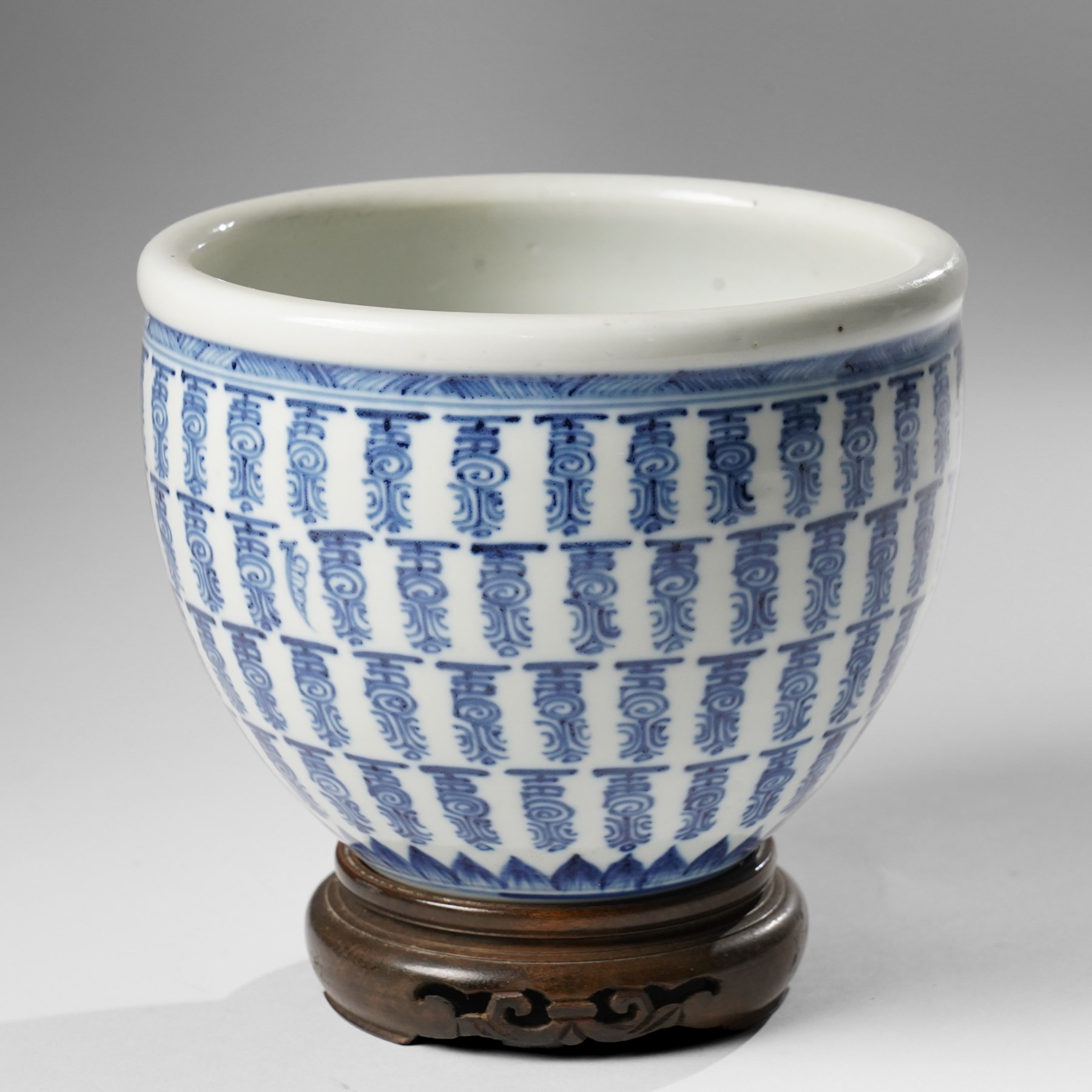 Chinese fish bowl, painted profusely with repeating symbols in blue, on hardwood stand, unmarked, including stand H16cm