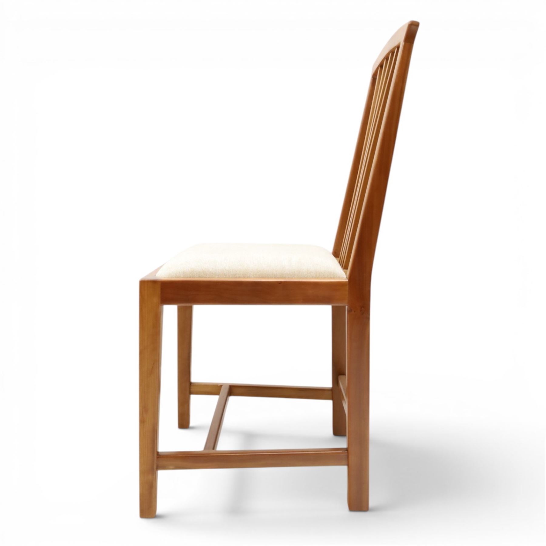 Knightman - set of nine cherrywood dining chairs, with fan splat backs and upholstered seats, raised on square legs joined by stretchers, comprising chairs of slight differing widths and one chair with turned front legs and orange upholstery and no Knight carving, the rest with recessed carved knight trademark, by Horace Knight of Old Mill Furniture, Balk near Thirsk 