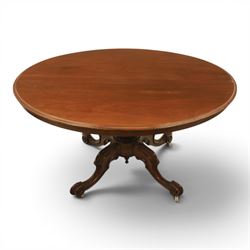 Victorian mahogany oval centre table, raised on turned column with four carved legs, ceramic castors