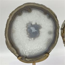 Pair of white agate slices, polished with rough edges raised upon gilt metal stands, H24cm