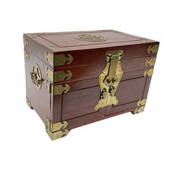 Chinese hardwood jewellery box mounted with engraved brass fixtures, the two exterior doors revealing three drawers below the hinged upper lid, lined with red material decorated with floral sprays, H25cm, W36cm, D23cm