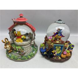 Six Disney Winnie The Pooh snow globes, to include four Halloween examples, including Tigger's Haunted House, together with Winnie The Pooh Gazebo snow globe and Bonfire snow globe, all with boxes