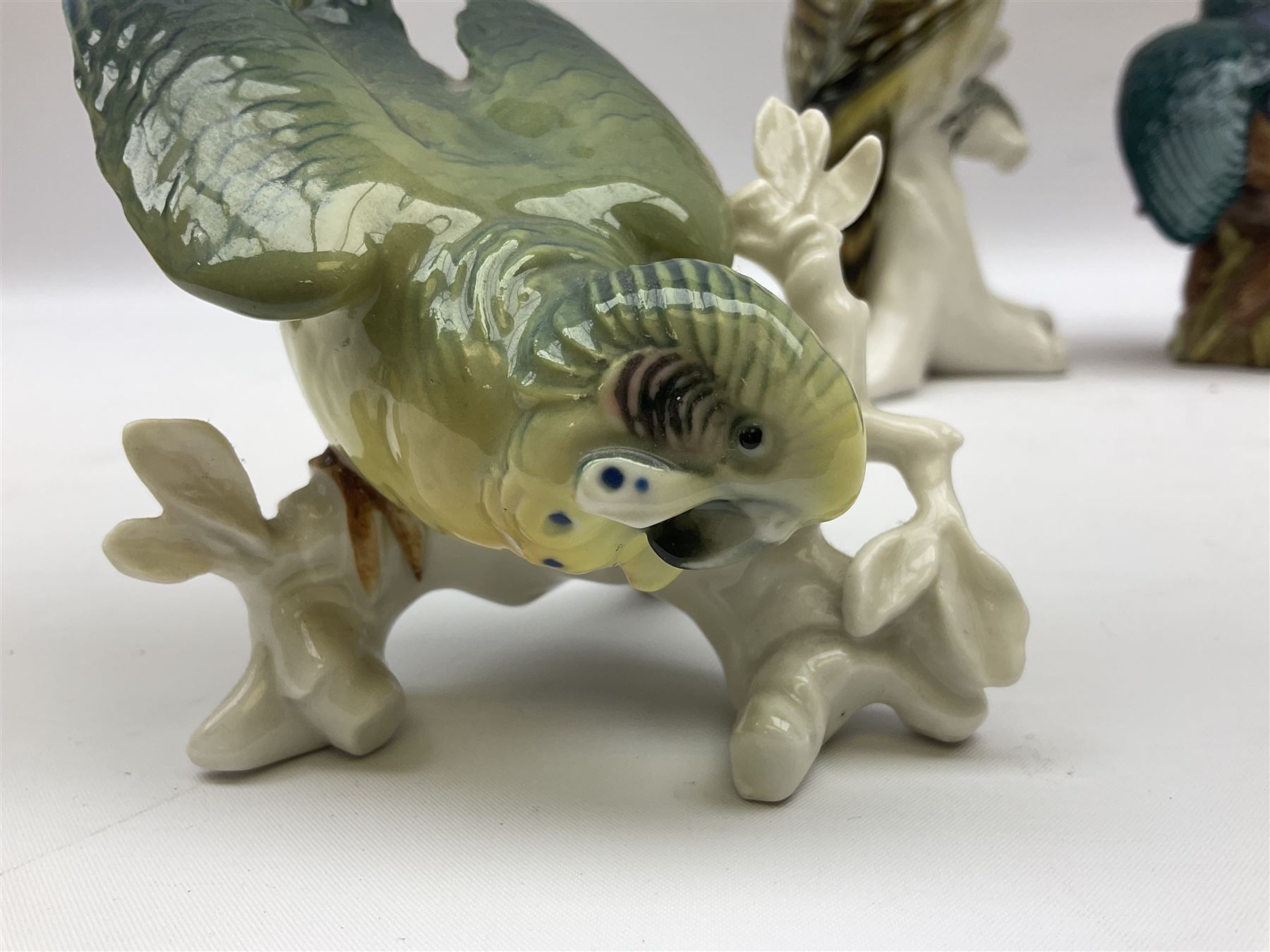 Karl Ens figure of a green woodpecker, modelled perched upon branch, model no. 7527, together with Karl Ens figure of budgie and Beswick Kingfisher no. 2371, all with printed marks beneath, tallest H25cm