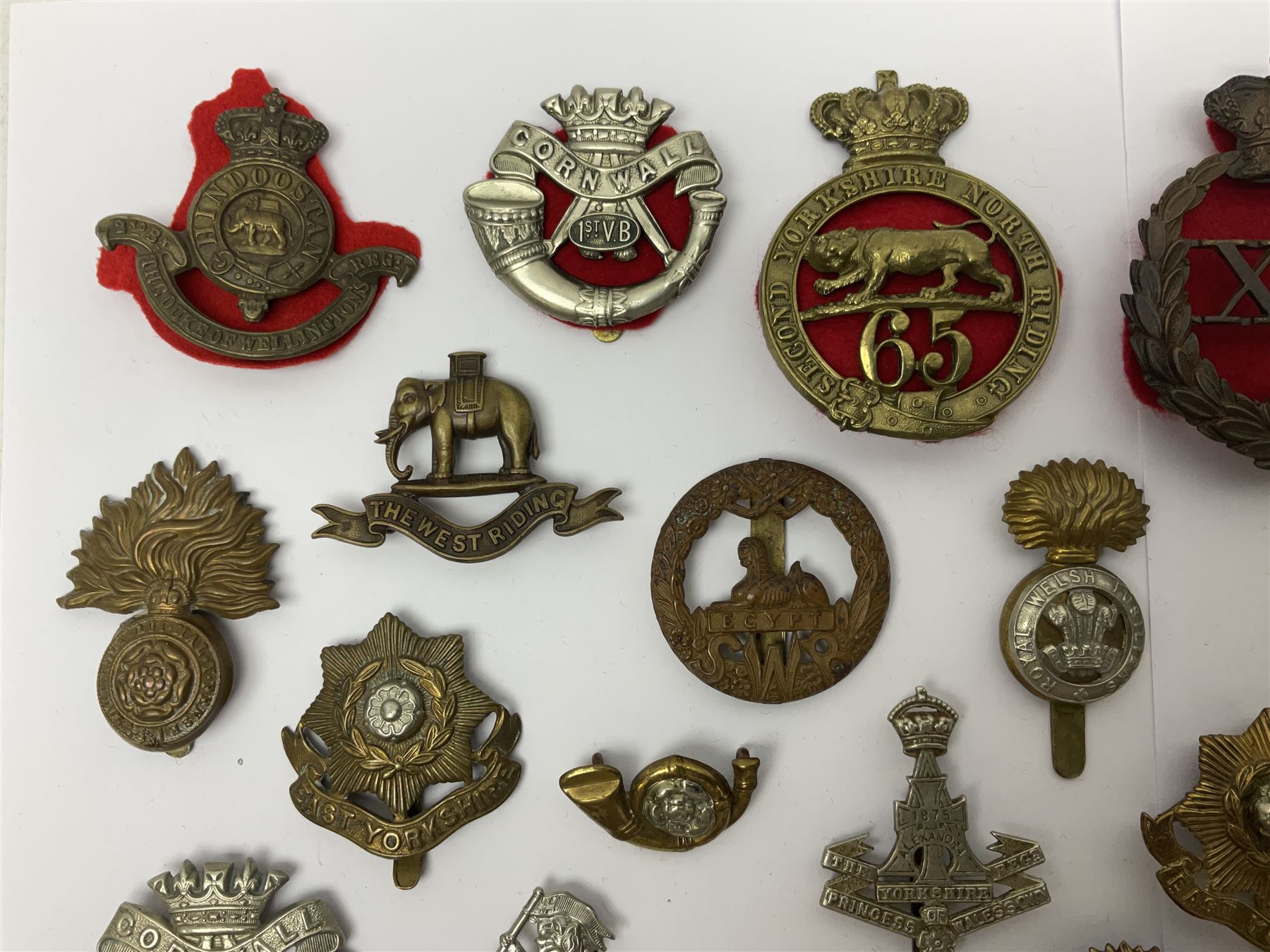 Over thirty regimental cap badges for fusiliers, Yorkshire interest, Light Infantry etc including Royal Scots and Welsh fusiliers, Durham L.I., KO Yorkshire L.I., Oxford & Bucks L.I., Green Howards, East Yorkshire, West Riding, York North Riding etc 