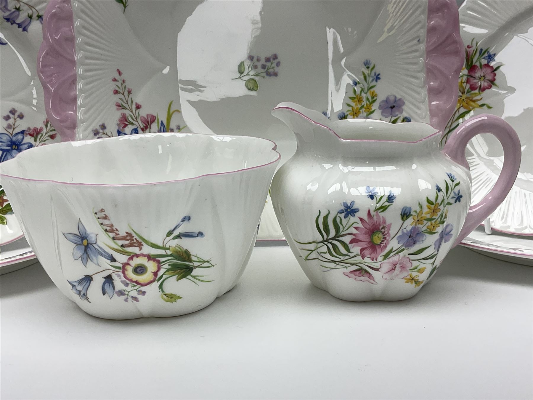 Shelley Wild Flowers pattern part tea service, comprising four cups and saucers, four dessert plates, cake plate, milk jug and open sucrier