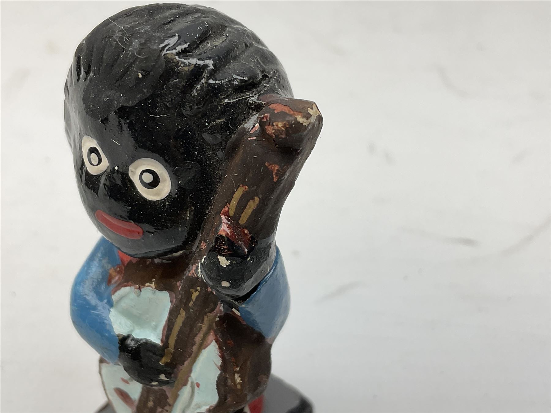 Robinson Jam plaster Golly band, including drummer and singer, H7.5cm

Originally handmade by mothers in Africa for their children from old fabric and cloth, the golly doll was adopted as the mascot and trademark for the Robertson's confectionery brand around 1910 after the company's founder John Robertson visited the US and noticed children playing with them. Robertson's Gollies have been collected by people across the UK and around the world for generations but garnered a contentious image in the 1980s because of links to racism. The trademark was removed from Robertson's branding in 2001.