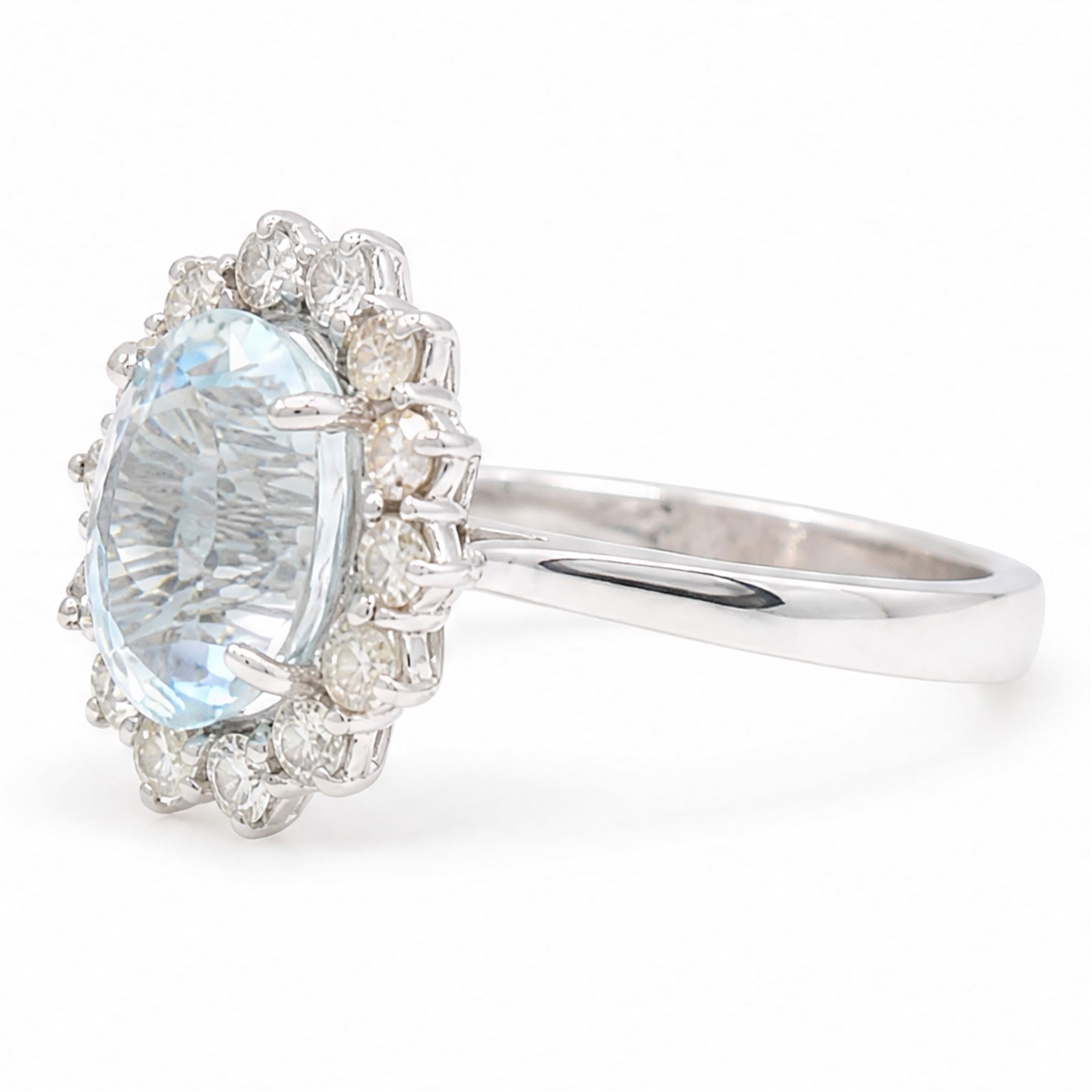 18ct white gold aquamarine and diamond cluster ring, single oval cut aquamarine of approx 2.80 carat, surrounded by fourteen round brilliant cut diamonds, hallmarked, total diamond weight approx 0.60 carat