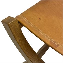 Mouseman - oak curved X-framed stool with slug tan leather seat, carved with mouse signature, by the workshop of Robert Thompson, Kilburn