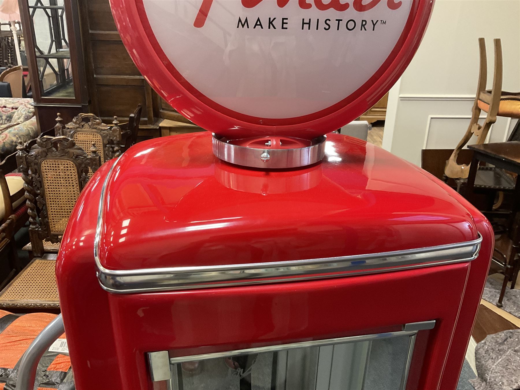 Roadside Relics Fender Custom Shop guitar display case, modelled as an American petrol pump, with a circular two-tone Fender logo light upon the pillar box red cabinet, three sides with glazed panels and chrome detailing, one etched with Fender logo, the interior with removable guitar stand, height including light 184cm