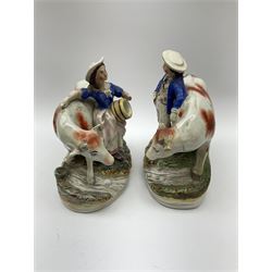 Pair of Victorian Staffordshire Pottery Figures, modelled as a milkmaid and farmer with cows, on naturalistic modelled oval bases H21.5cm.