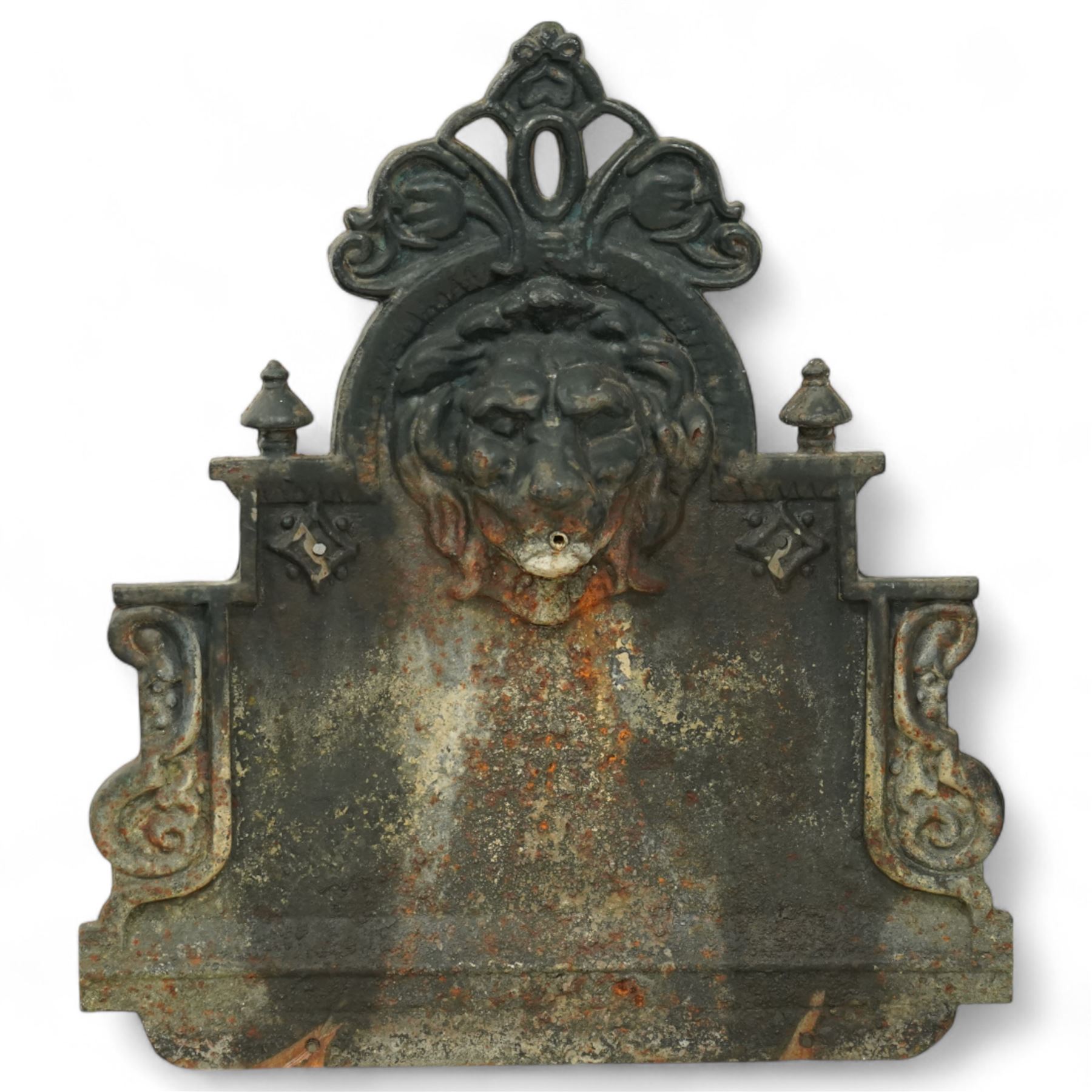 Victorian cast iron ‘lavabo’ lion's head wall fountain, the arched and crested backplate centred with a lion's head spout, with flanking scroll columns and gadrooned basin with flared rim

