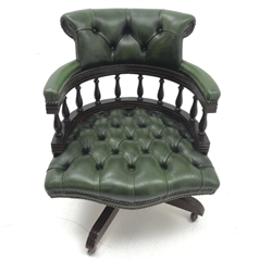 Captain's swivel chair upholstered in green buttoned leather on swivel base, W62cm