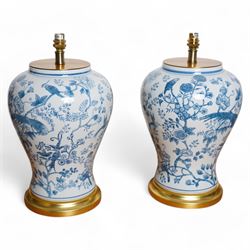 Pair of large table lamps of baluster form, decorated with exotic birds perched in flowering trees, upon gilt circular bases,  H68cm including shade