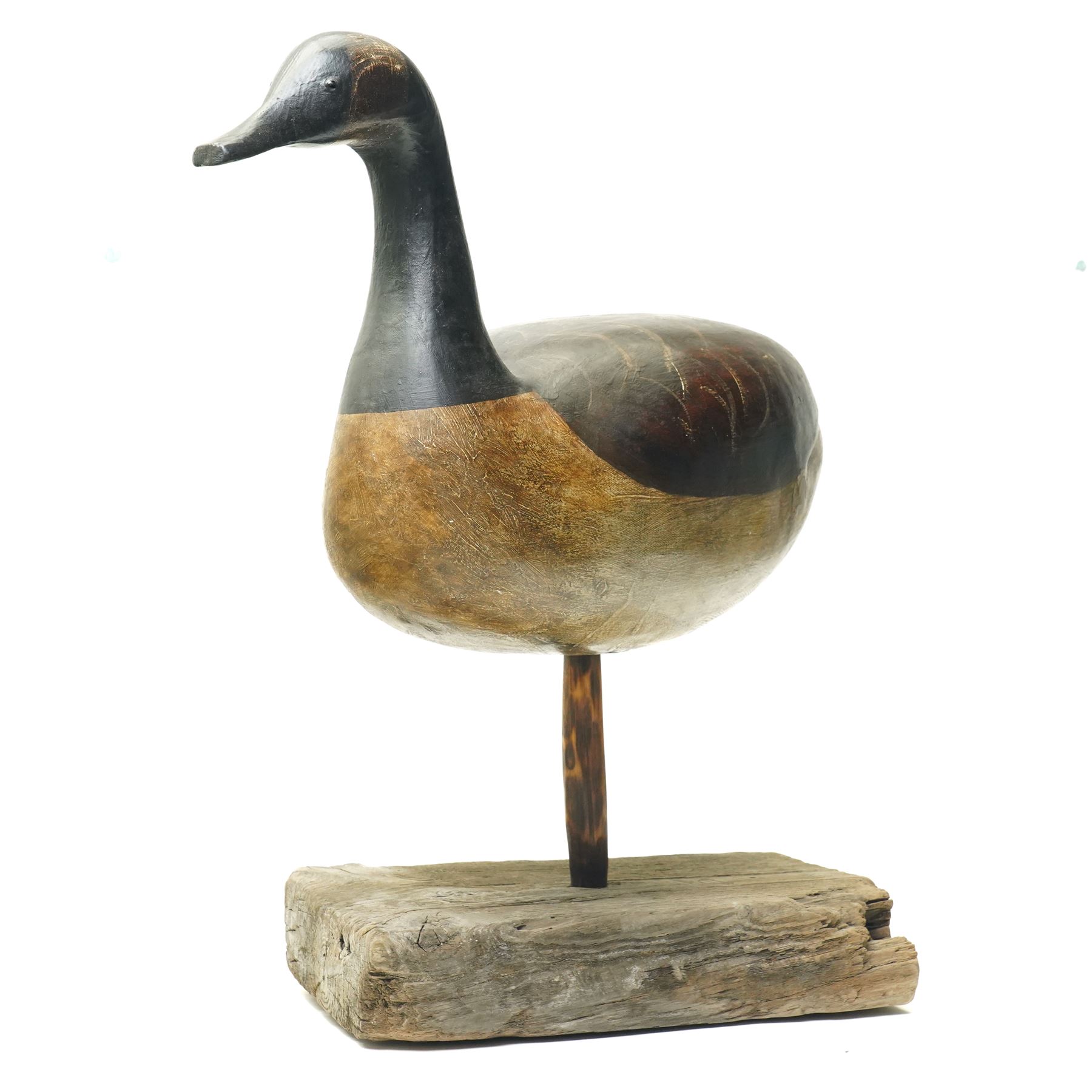 Guy Taplin (British 1939-): 'Canada Goose', carved and polychrome painted wooden sculpture of a bird, on a naturalistic driftwood base, H64cm
Provenance: purchased directly from the artist in the 1990s