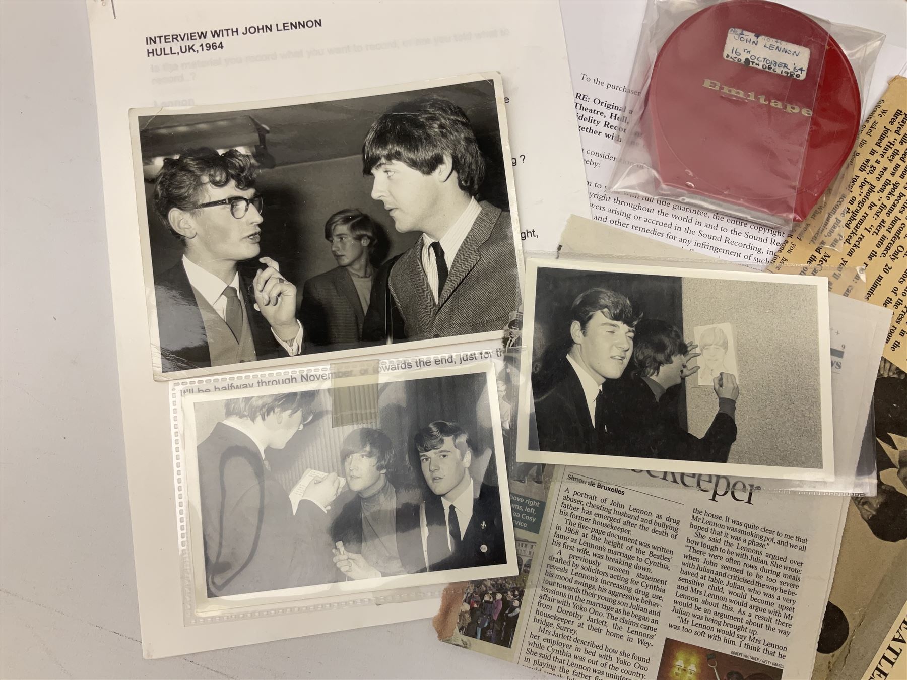 John Lennon interview recording conducted by John Hill student of Hull University on the 16th October 1964 at the A.B.C. Theatre Hull on behalf of the university newspaper 'Torchlight'. The interview lasts eight and a half minutes. It catches John in an upbeat breezy mood answering questions about the following topics: the song writing process ('sometimes you get an idea ....I dunno....my left leg.... and then write about that....'), recording (.... 'they just say - you're recording on such and such a date and they hope we turn up with some good songs written ....'), an alternative career path (.... 'I'd probably just have been a lay-about....'), failing at college (....'some other lads did my exams for me ....'), reading matter ( Clockwork Orange, Alice in Wonderland), his books of prose, tastes in music, the Blues, The Rolling Stones, being a Beatle vis-a-vis anonymity ('Whatever I'd be I'd choose to be rich .... who wants to walk down the street?').
The interview was recorded on 1/4 inch Emitape on a Fi-Cord Fidelity Recording machine. The reel-to-reel tape comes in its original Emitape plastic box and is accompanied by the Fi-Cord reel-to-reel machine on which the interview was originally recorded. Also included in this lot are a copy of the 'Torchlight' newspaper from 21st November 1964, two photographs of the interviewer with John Lennon (the interviewer is pictured to the left of John Lennon in the photograph in which John is signing a sketch) and one photograph of Paul McCartney with another reporter, the largest measures 12 x 16.5cm and a transcript of the interview. The recording is also accompanied by the original Fi-Cord tape recorder with microphone, four original 2v batteries and battery charger. The tape recorder has been adapted to take 3xAA batteries and the 2v battery charger is fitted with a standard UK 3-pin AC plug. The interview was recorded in the press room prior to the Beatles concert at the A.B.C. Theatre and is sold with copyright.
