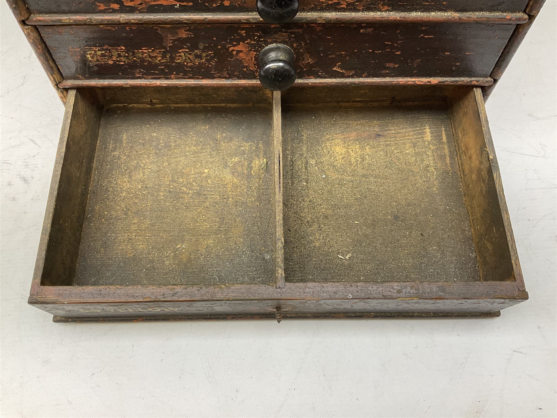 Early 20th Century Dewhurst table top chest, decorated with gilded 'Dewhurst's Sylko Machine Twist Strong Lustrous' lettering above six long drawers with names and numbers of cotton also detailed in gilt, H39cm