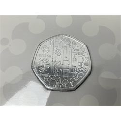 Twelve The Royal Mint United Kingdom brilliant uncirculated fifty pence coins, including 2018 '40 Years of The Snowman', 2018 'Paddington at the Station', 2020 'Peter Rabbit', etc., all housed in card folders