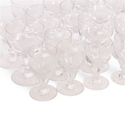 Georgian shaped drinking glasses, comprising eleven larger, H12.5cm, and eight smaller, H10.5cm, each with ovoid bowl upon knopped stem and circular foot