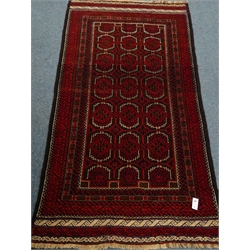  Old Baluchi black and red ground rug, repeating border, 217cm x 116cm  