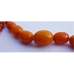  Single strand amber bead necklace, with gold clasp stamped 9ct  
