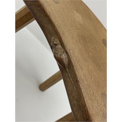 'Mouseman' oak three legged stool with dished kidney shaped seat, tapered octagonal supports, with carved mouse signature, by Robert Thompson of Kilburn
