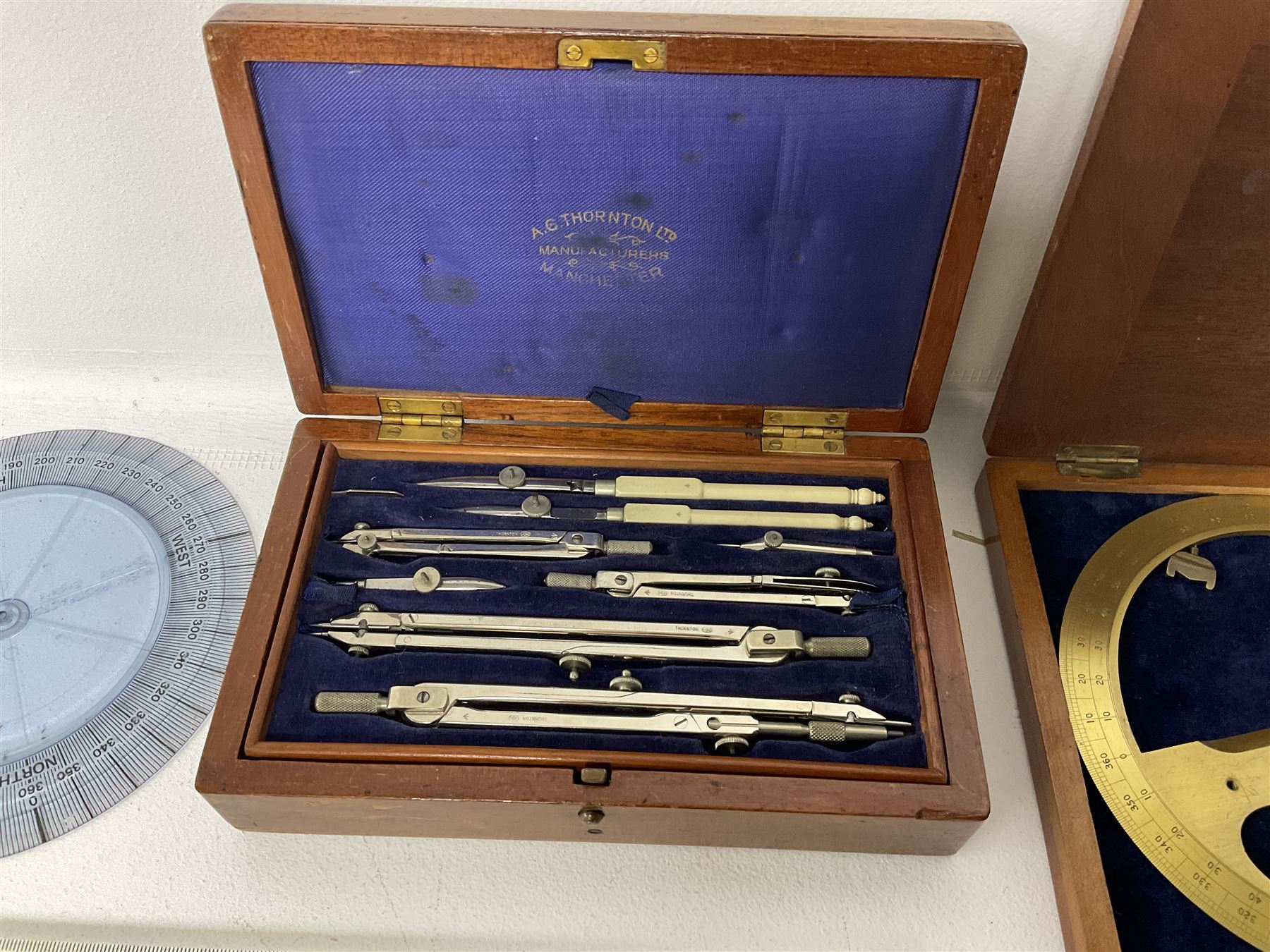 Brass 360 precision drafting protractor by Chadburn bros, in mahogany case, A G Thornton Drawing instruments in a mahogany case, together with P.I.C slide ruler, Nautical protractors etc 