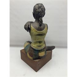 Composite bronzed sculpture, modelled as a woman sitting cross legged upon a wooden plinth, signed S.Tozer, H51cm