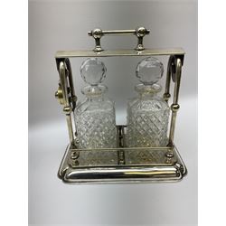 Early 20th century silver plated tantalus by John Grinsell & Sons of Birmingham, containing two crystal glass decanters, with key, H31cm