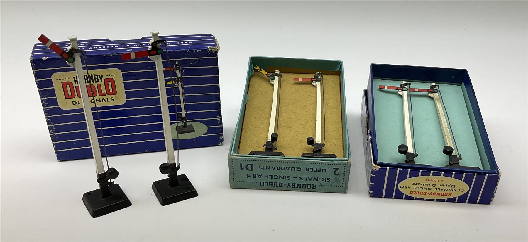 Hornby Dublo - twelve manually operated semaphore signals comprising one 5050 Signals Single Arm (D1) 2 Home, one 5060 Junction Signals (D3) 2 Home; D3 Junction Signal Upper Quadrant (1 Home 1 Distant); two 5055 Signals Double Arm (D2) 1 Home 1 Distant; two D2 Signals Double Arm (Upper Quadrant); three D2 Signals Double Arm Upper Quadrant Home - Distant; and two D1 Signals Single Arm Upper Quadrant; all boxed (12)