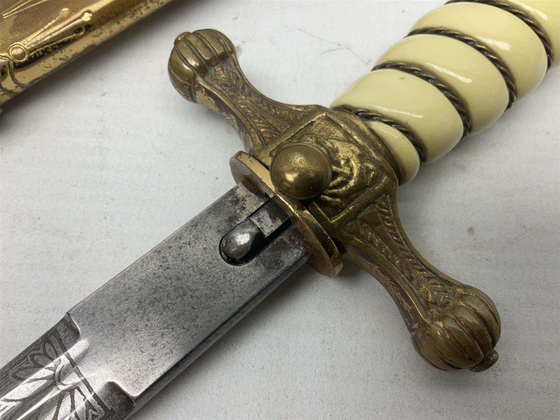 WW2 German kreigsmarine style dagger composed from various age parts, the post-war 25cm double fullered blade  with etched decoration and inscribed WKC with knight's head; in gilt brass scabbard with two rings L42cm overall