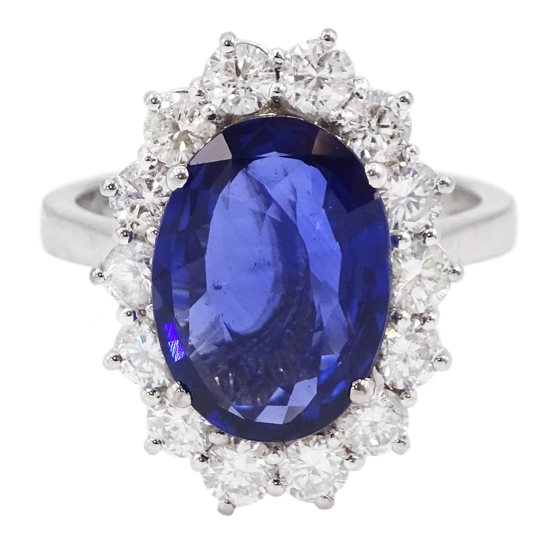 18ct white gold oval sapphire and round brilliant cut diamond cluster ring, hallmarked, sapphire approx 3.50 carat, total diamond weight approx 0.90 carat