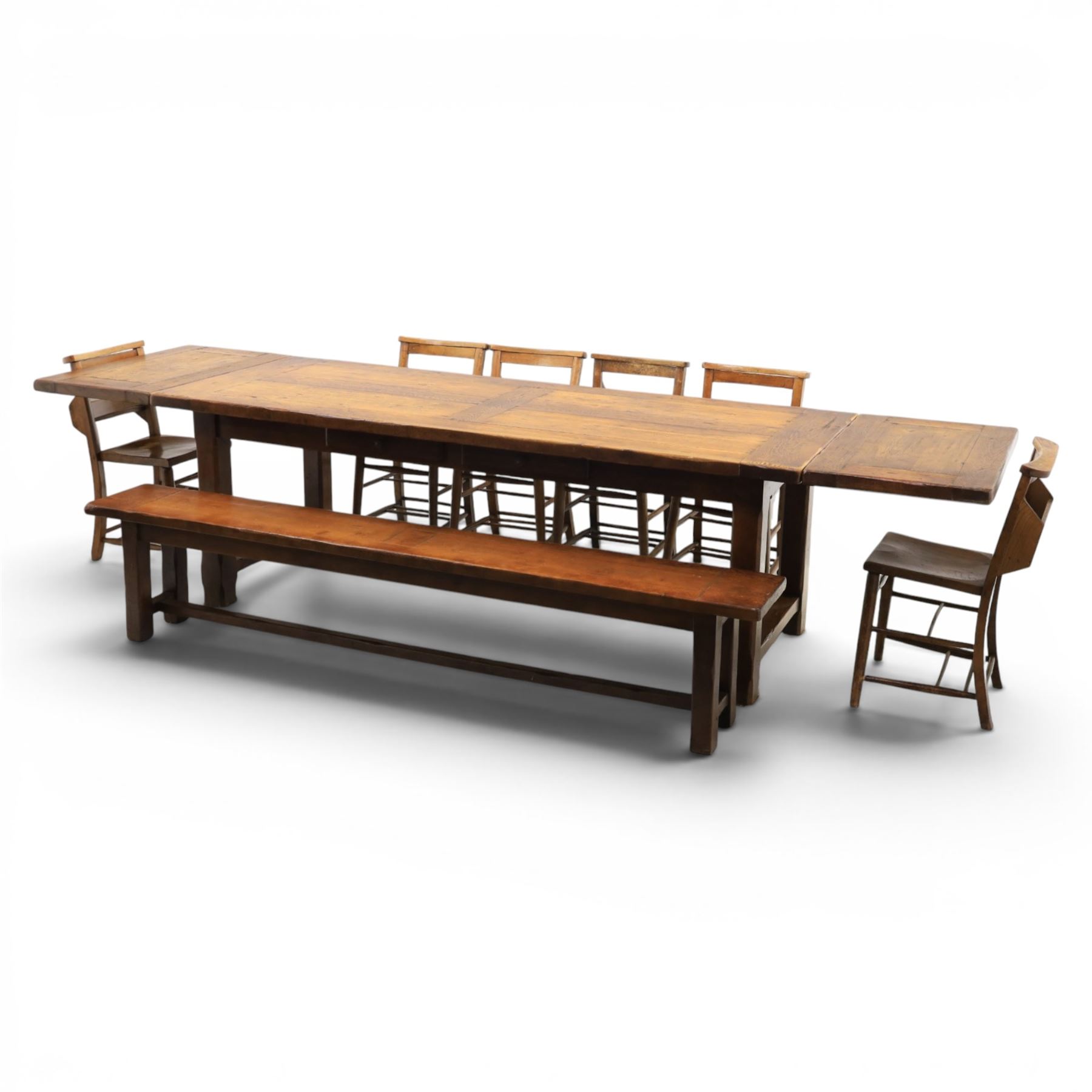 Country pine draw leaf table, bench seat and six chapel chairs, the top of plank construction, with two frieze drawers, additional leaves extending to 320cm, with bench seat and six elm chapel seats