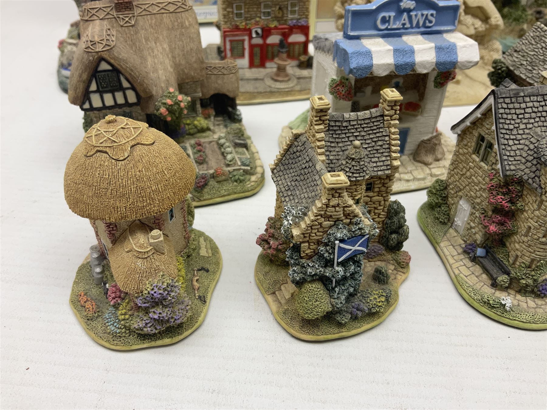 Twenty three Lilliput Lanes, including Village School, Lace's Shoe Shop, Cockles & Muscles, Scotland the Brave etc, together with The Leonardo Collection Paint Box Poppets and Gullivers World magazines 