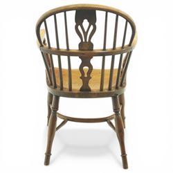 19th century low back elm Windsor armchair, hooped back with pierced central splat and radiating spindles, shaped arm bow over saddle seat, on turned supports united by crinoline stretcher