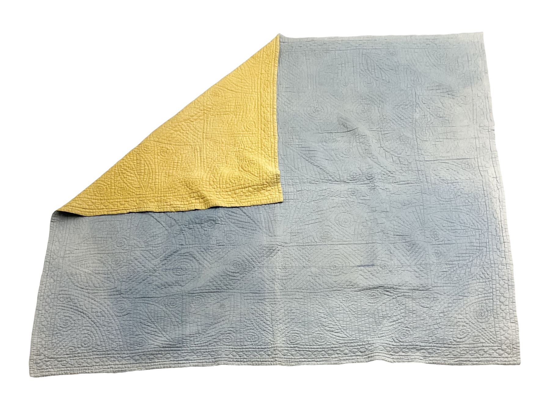 Early 20th century Welsh whole cloth sky blue quilt, in traditional quilting patterns, supported on yellow coloured backing, 174cm x 204cm