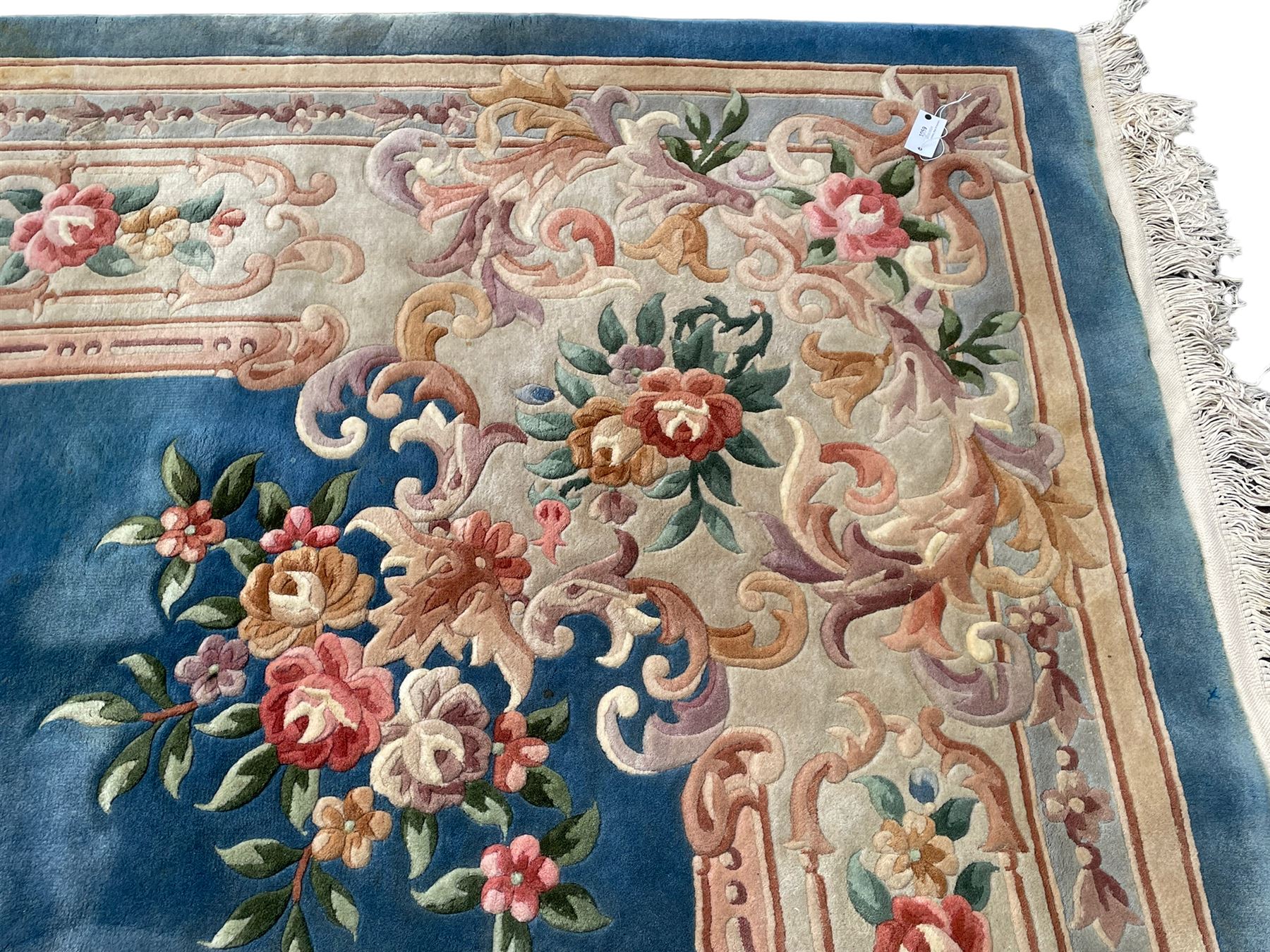 Large Chinese blue ground woollen carpet, overall floral design, central oval medallion surrounded by scrolling floral decoration, wide border with decorated with floral bouquets 