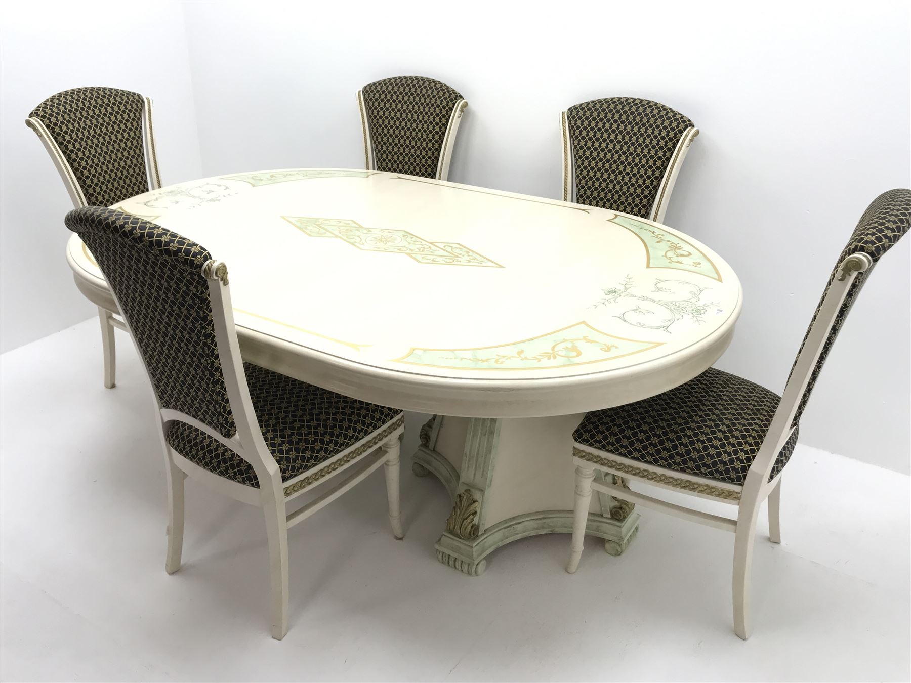 Italian style dining table, oval top with green marble finish spandrels, gilt scroll work and detail, central stepped lozenge motif, on two concaved square tapering pedestals with fluted uprights mounted with gilt acanthus scrolls (W198cm, H74cm, D130cm) and set five cream and gilt finished dining chairs, upholstered back and seat, turned tapering supports (W50cm)