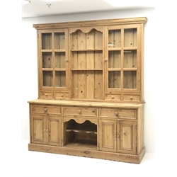 Traditional pine dresser fitted with three drawers and four cupboard doors, complete with glazed display plate rack, W183cm, D49cm, H208cm