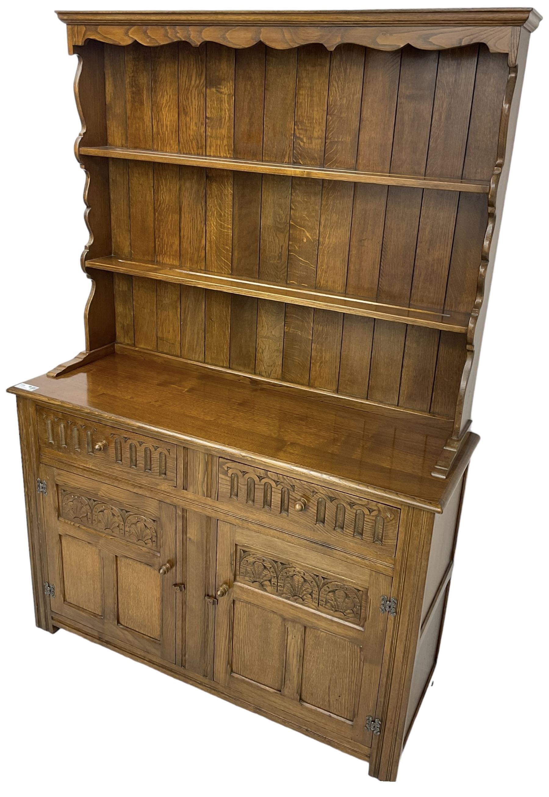 Mid-20th century oak dresser, raised two heights plate rack over two drawers and two cupboards