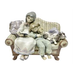 Lladro figure group, Big Sister, modelled as two girls and a puppy seated on a sofa, no 5735, H16cm