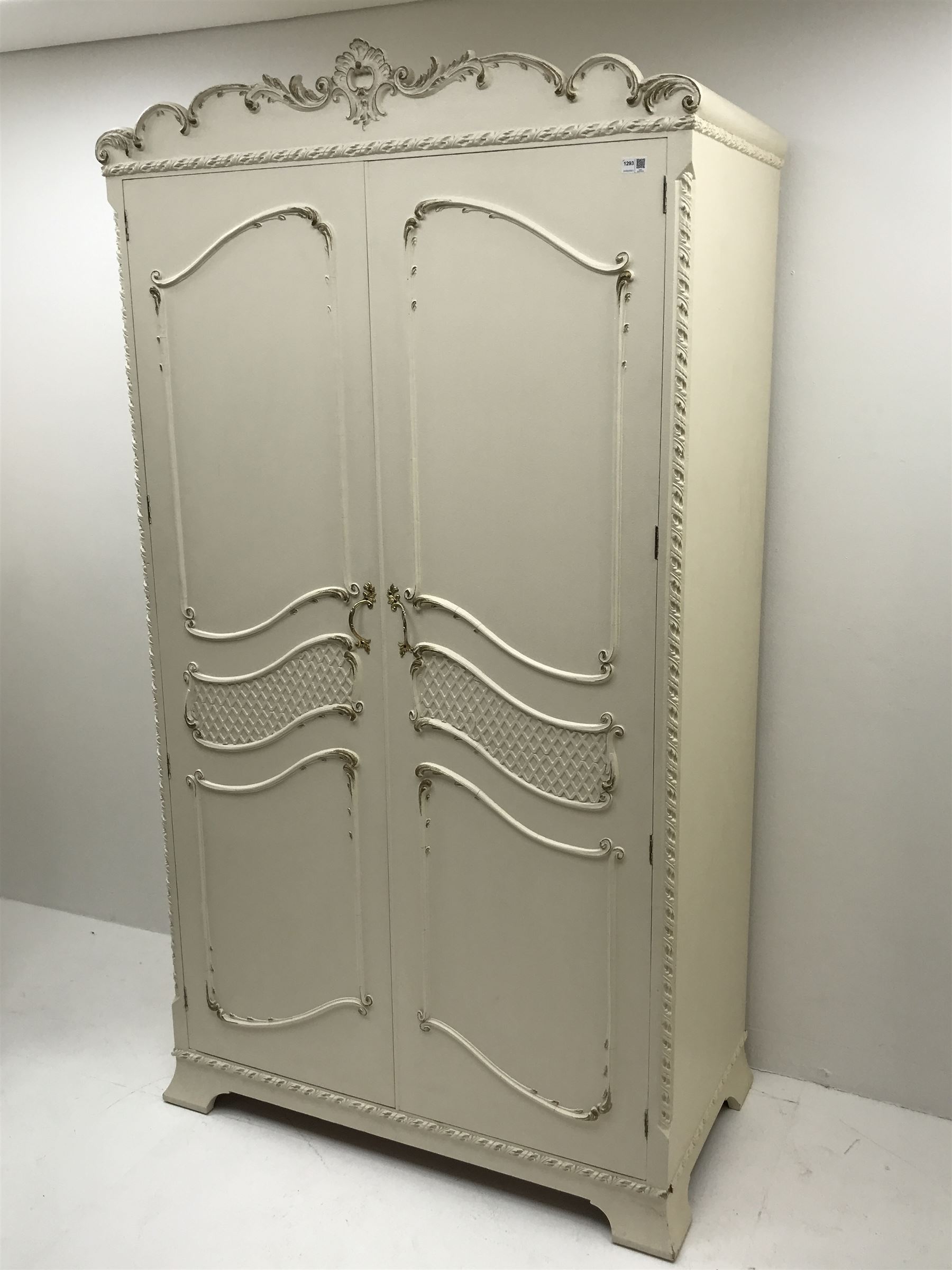 Late 20th century French style white and gilt double wardrobe,  shell carved cresting rail, two doors enclosing fitted interior, shaped bracket supports
