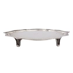 George III silver teapot stand, of shaped form with engraved foliate border and central initial, upon four bracket feet, hallmarked John Langlands I & John Robertson, Newcastle, no date letter present, W18.5cm, approximate weight 4.65 ozt (144.7 grams)