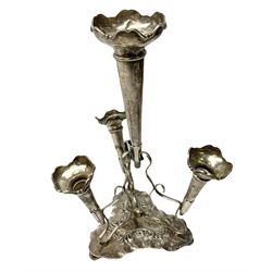Four hallmarked silver trumpet vases, total weight 108g, upon silver plated stand with foliate decoration and bun feet