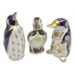 Three Royal Crown Derby paperweights, comprising Puffin with gold stopper and original box, Platypus with silver stopper and Penguin with missing stopper, all with printed marks beneath 