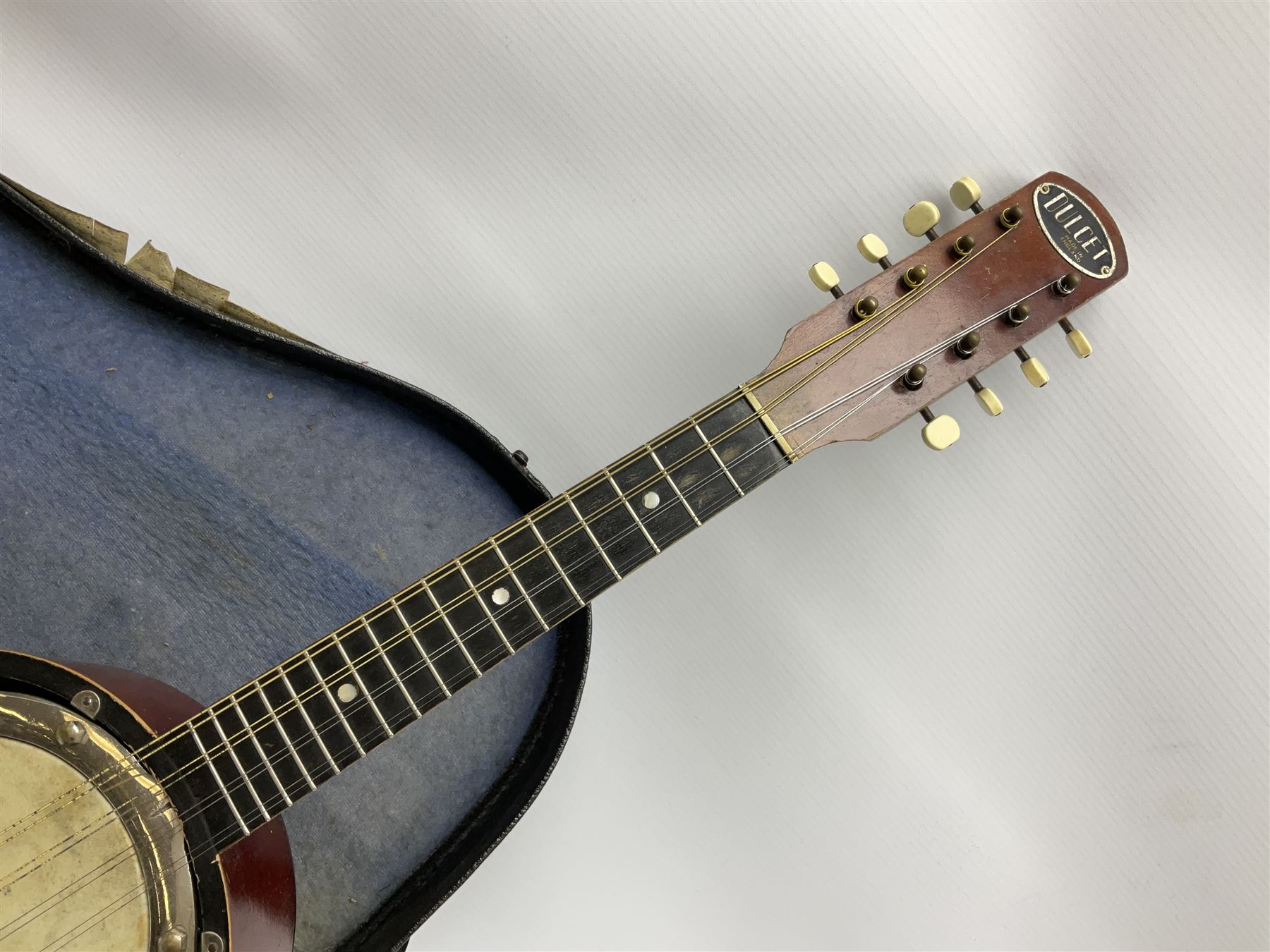 Dulcet eight-string banjo mandolin with mother-of-pearl inlaid ebonised fingerboard L55.5cm; cased; and Irish mahogany bodhran hand drum with inlaid stringing and vellum top D46.5cm; in soft carrying case with double ended beater (2)