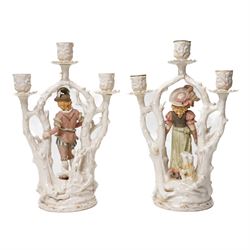 Alfred Stellmacher - Pair of three branch candelabra of naturalistic form, each with a central standing figure on circular bases with gilt highlights H37cm