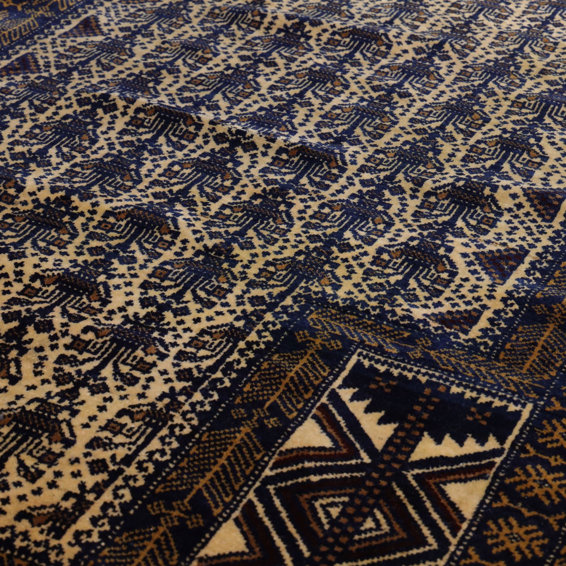 Afghan Ersari hand-knotted rug, apricot field decorated with three large octagonal gul medallions filled with geometric floral motifs, flanked by small tribal devices, end fringe fraying 97x167cm, together with a Baluch prayer rug, decorated with stylized tree motifs arranged in vertical rows beneath a stepped mihrab arch with multiple narrow borders of angular tribal motifs in shades of indigo, brown, and ochre fraying to flatweave ends, 134x84cm, (2)