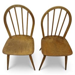 Ercol - Windsor dining chairs, set of four, each with rounded hoop back and four stick spindles, shaped elm seats with exposed plugs, raised on splayed beech tapering legs